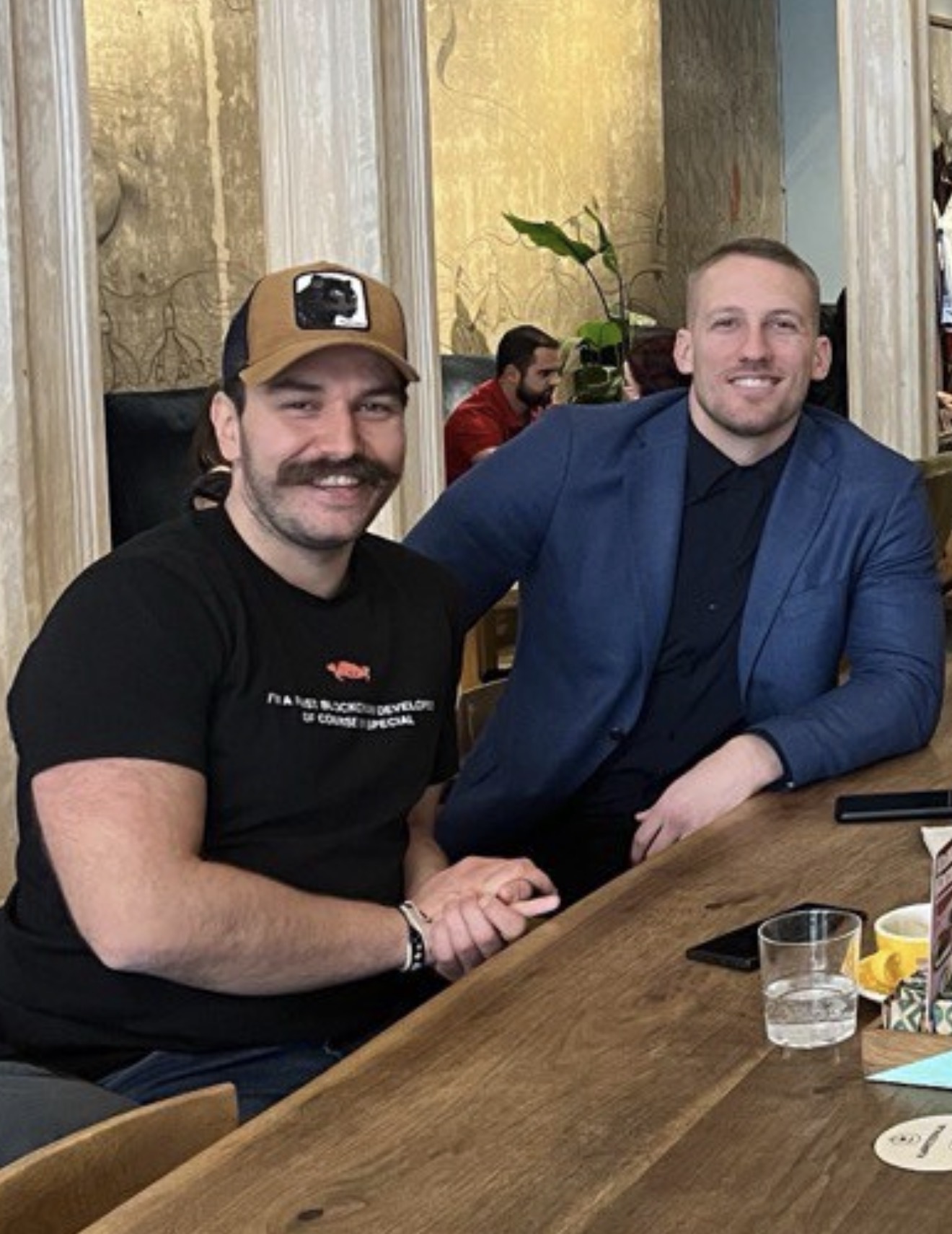 Austin sitting with another person at a table